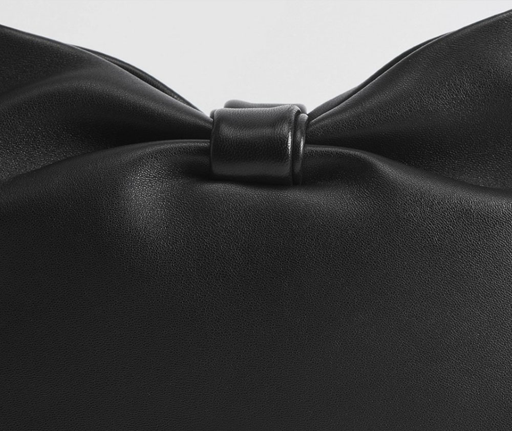 Close-up of the signature bow detail on the Replica Dior Bow Bag — iconic black luxury handbag design
